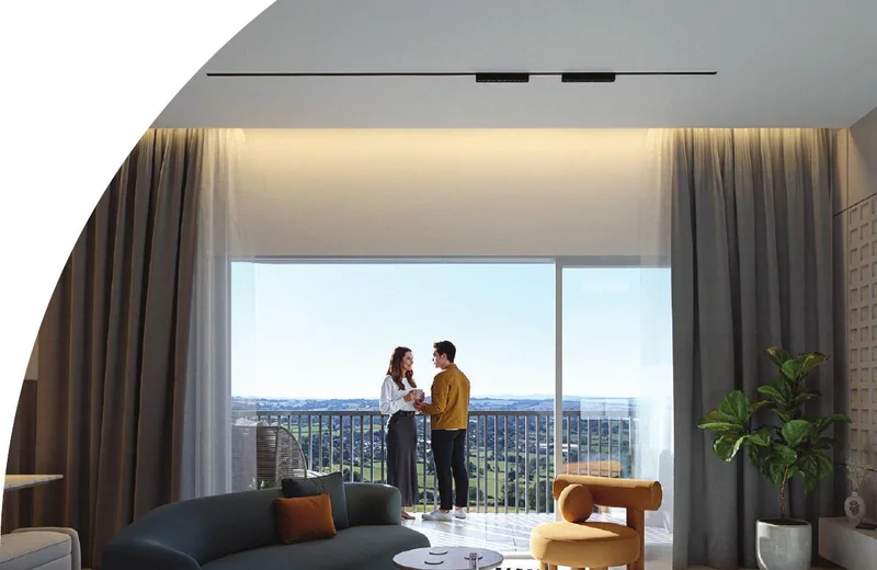 Living room at Solcrest opening to a wide balcony with skyline views — artist's impression